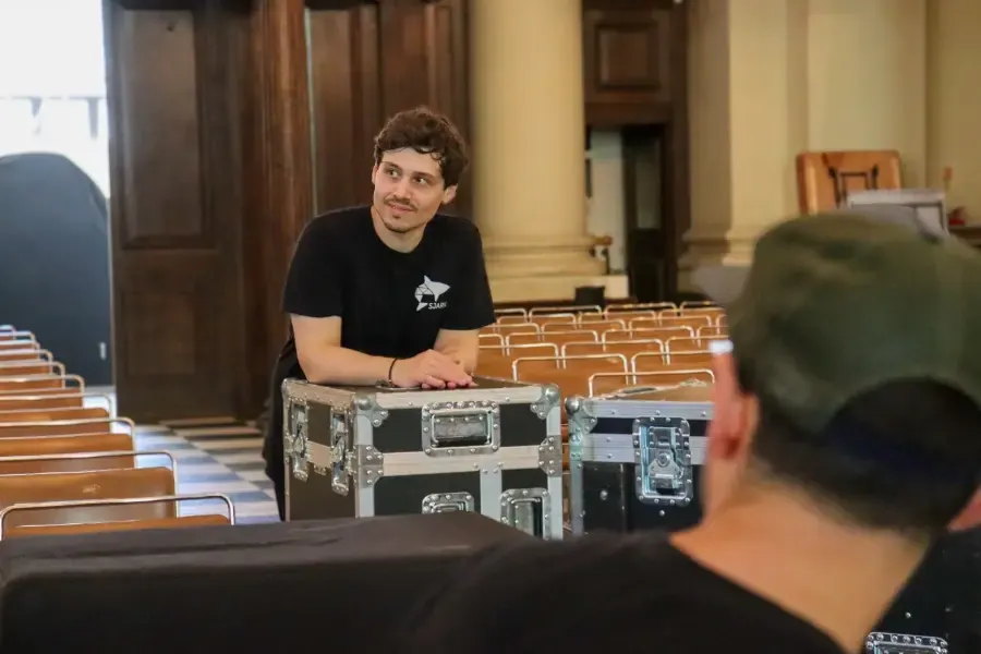 SJARK engineer setting up a flight case in a concert hall