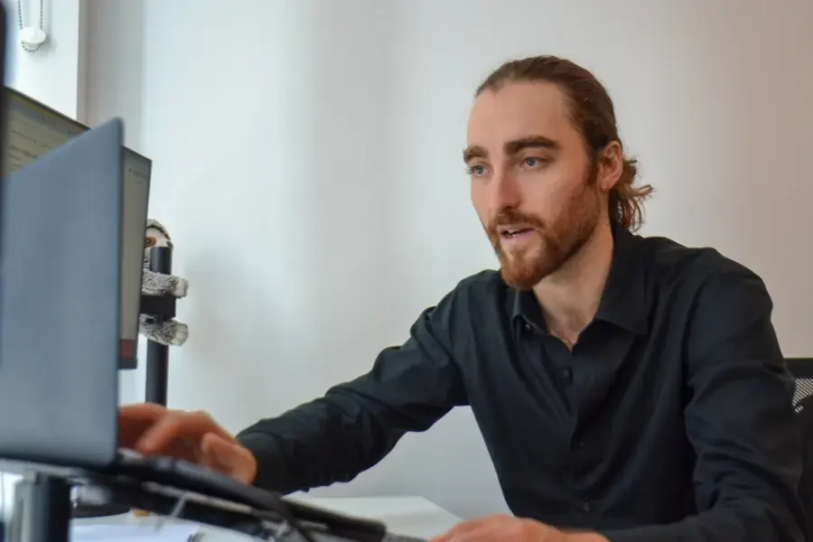SJARK project manager on a call at his desk